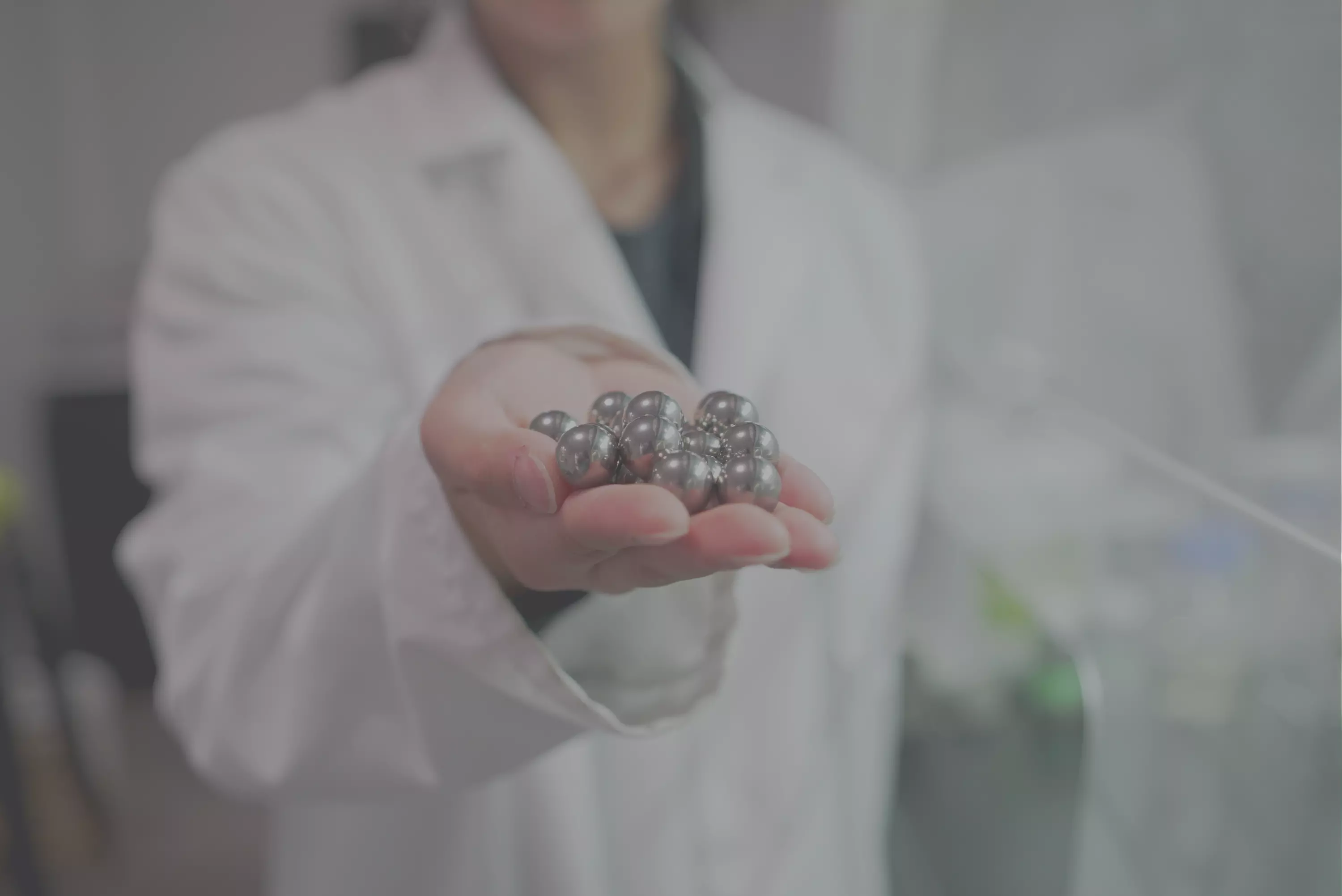 Photo of scientist hold MCD ball milling balls
