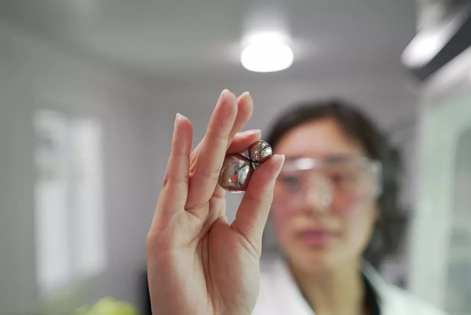 Mechanochemical destruction scientist holding ball milling balls